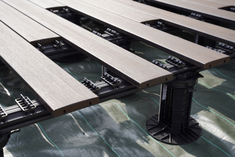 Timber decking boards partially attached to secret clip decking system.