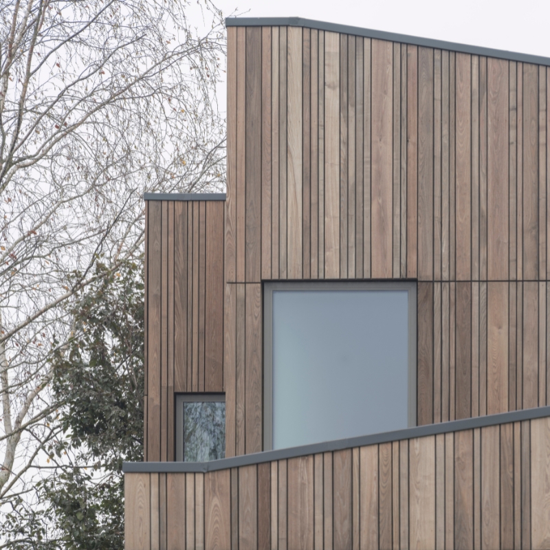 Mixed width ThermoWood Ash timber cladding.