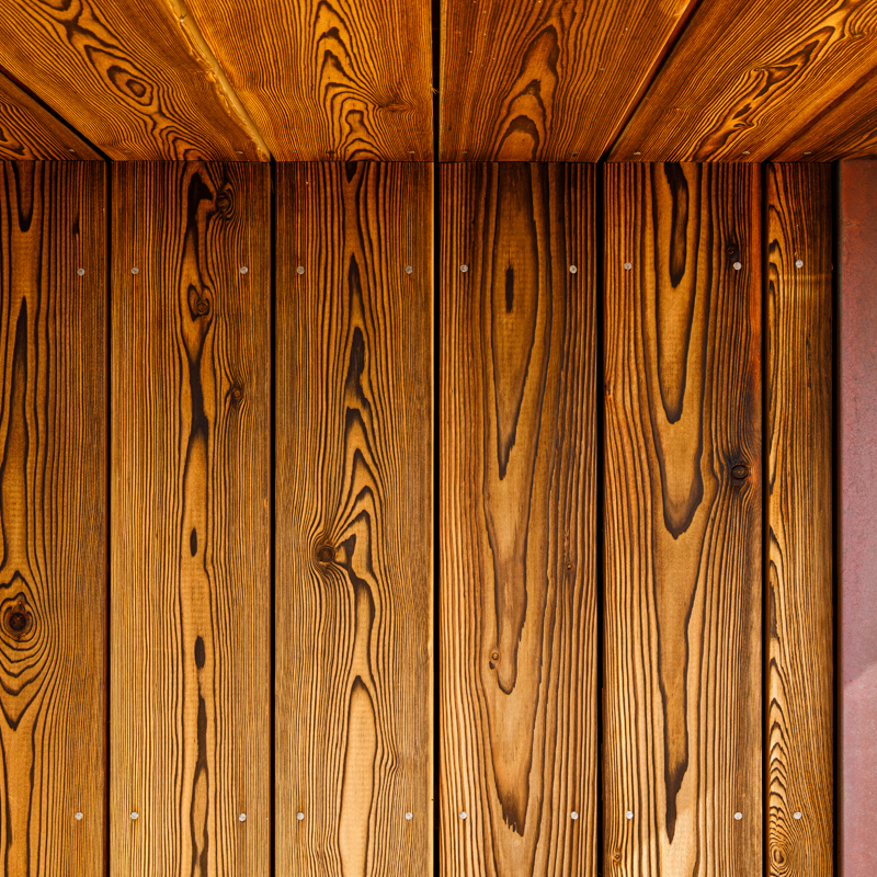 Section of larch timber wall showing burned mokuzai effect