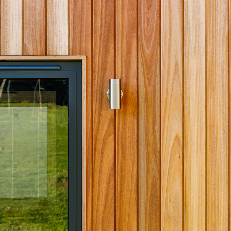 Timber clad wall with section of window visible