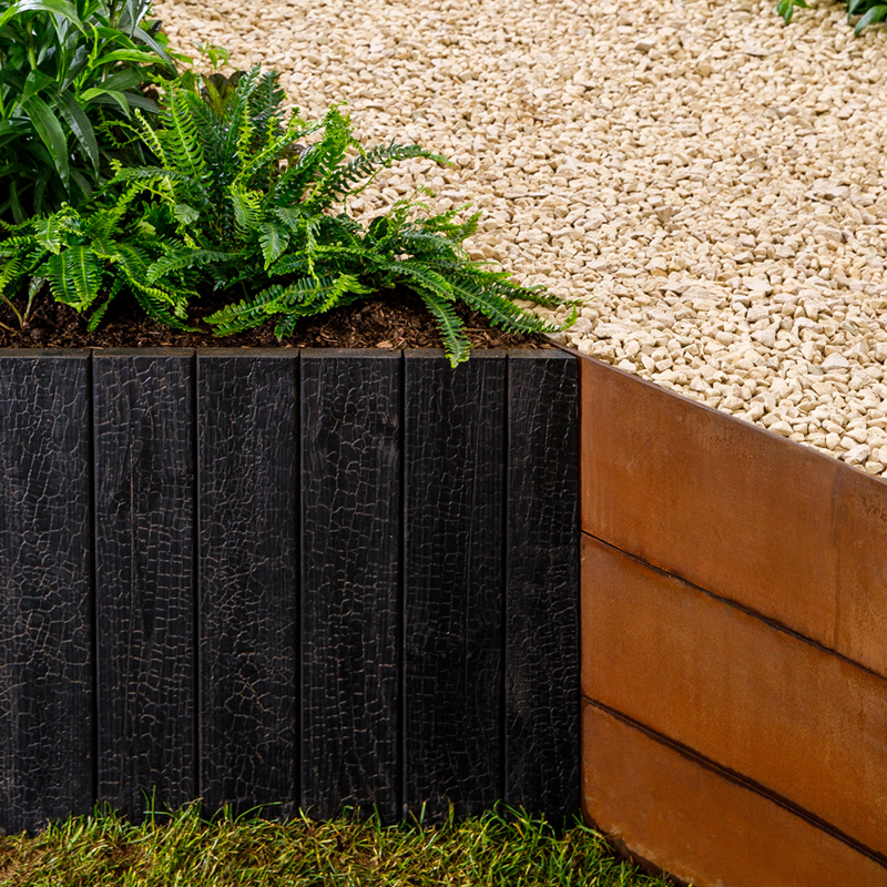Close up of timber garden wall showing black charred mokuzai effect