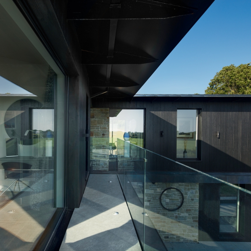 Modern balcony clad in Millworks Mokuzai 'Charred' timber cladding.