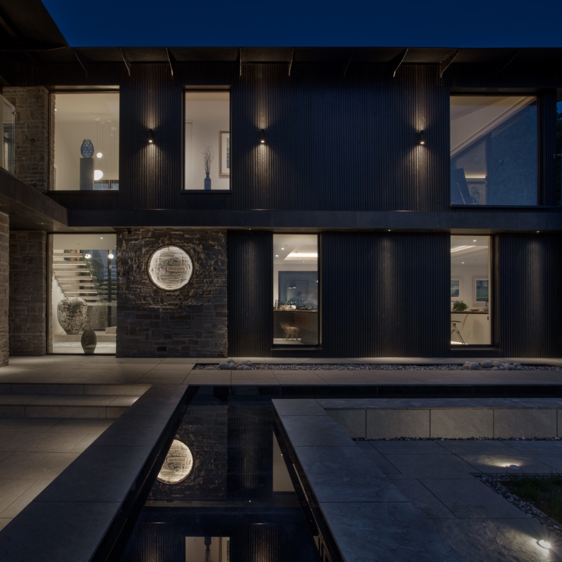 Millworks Mokuzai 'Charred' timber cladding with modern uplighting.