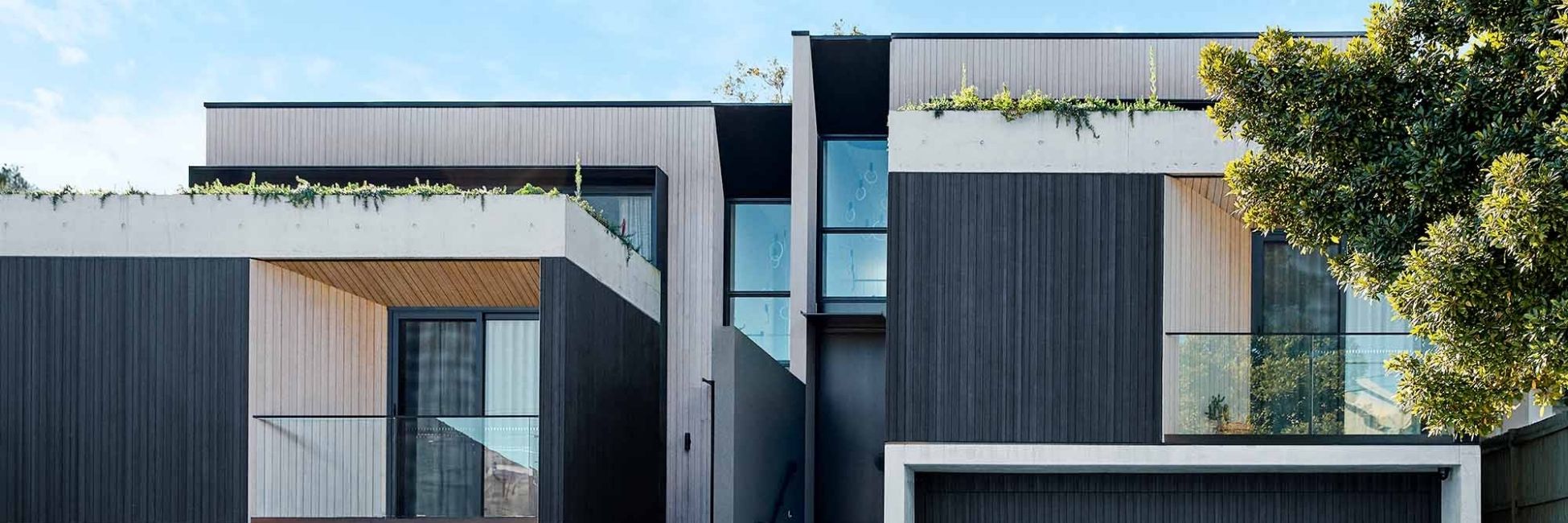 Abodo Vulcan Cladding shown in a mixed finish of Black and Patina.