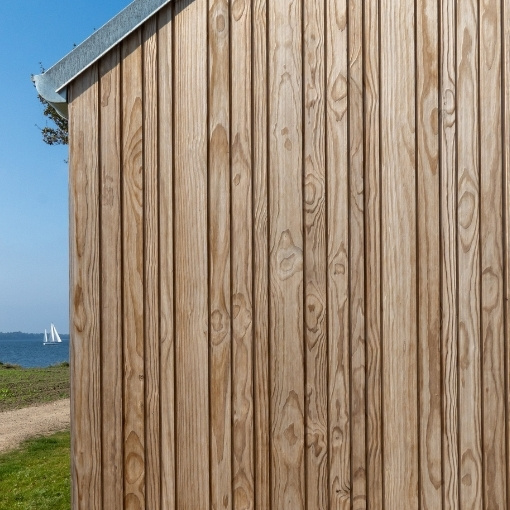Imbue timber cladding left uncoated to weather naturally.