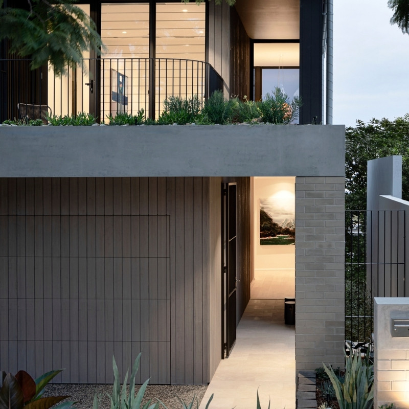 A low level garage door clad in Silver Grey Abodo Vulcan timber.