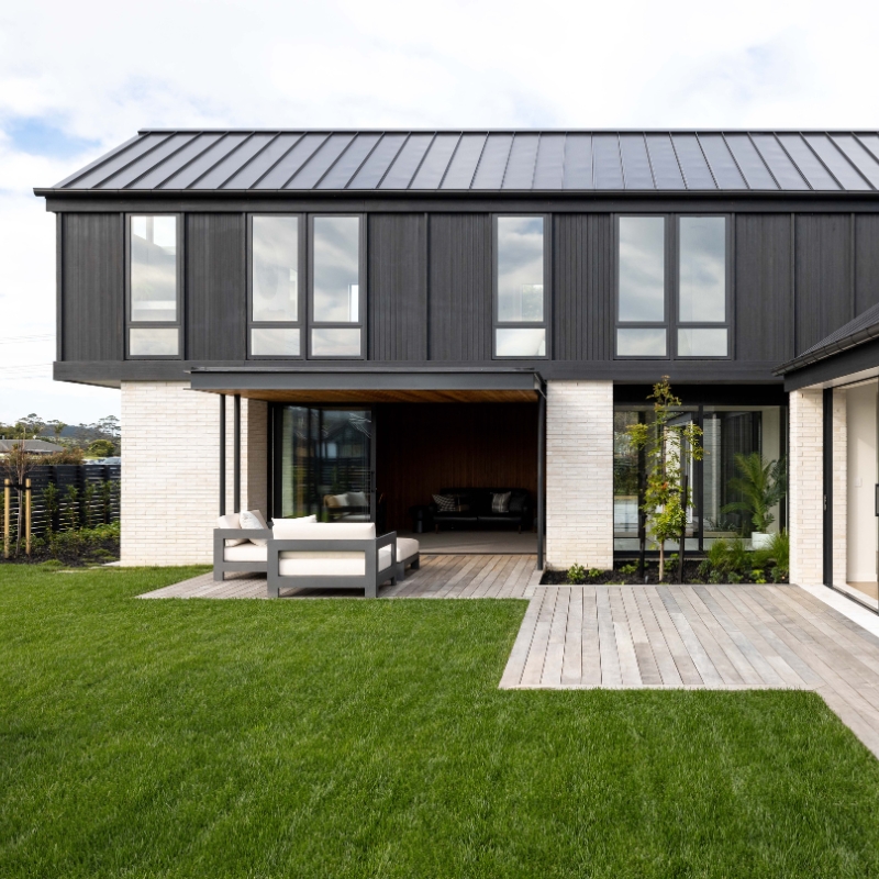 Black timber cladding shown on top storey of modern home.