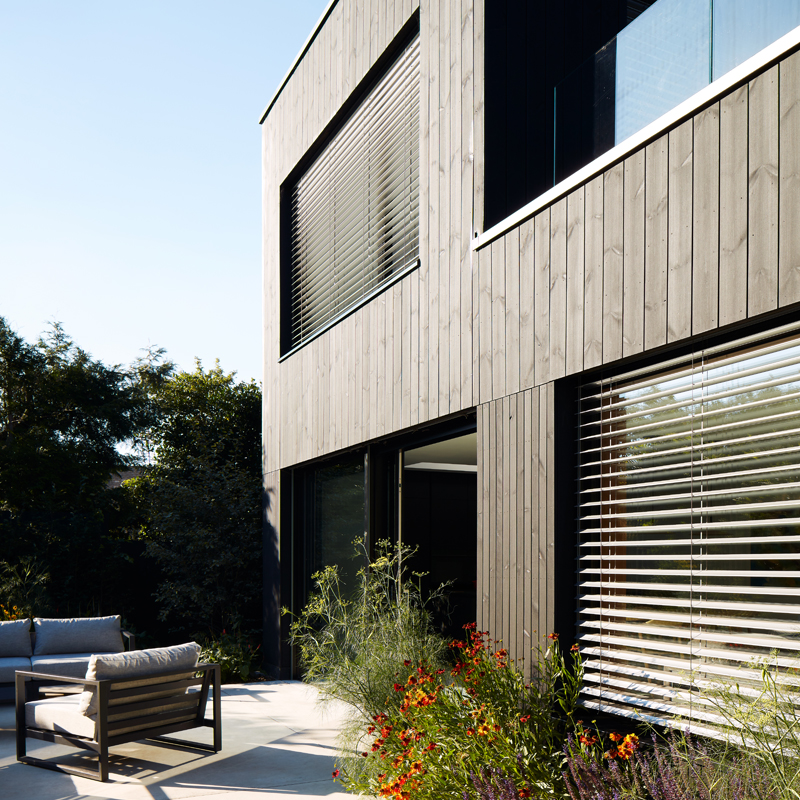 MillworksLtd-ThemoWood-Pine-External-Cladding Rear view of Black ThermoWood® Pine external cladding taken from patio.